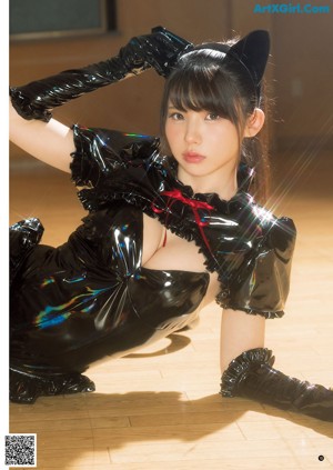 A woman in a black cat costume posing for a magazine.