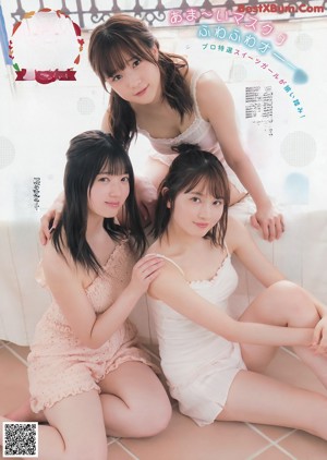 A group of three women in bikinis standing next to each other.