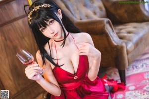 A woman in a red dress and black stockings posing for a picture.