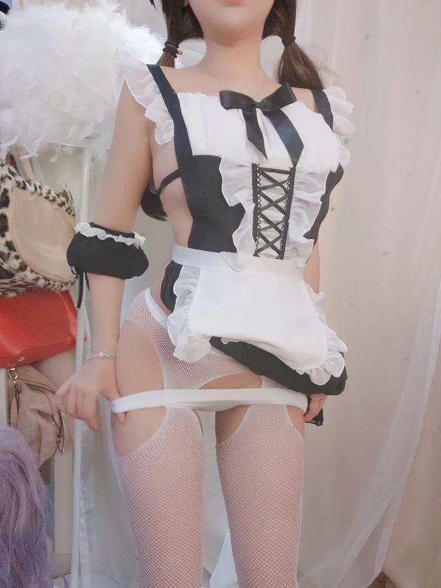 a woman in a maid outfit posing for a picture