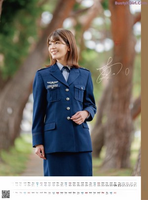 A woman in a school uniform is smiling for the camera.