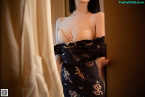 A woman in lingerie sitting on a wooden shelf.