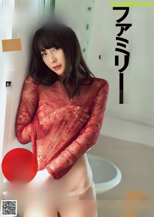 A woman in a red lingerie is posing in a bathroom.