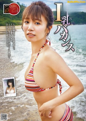 A woman in a black bathing suit standing in a pool.