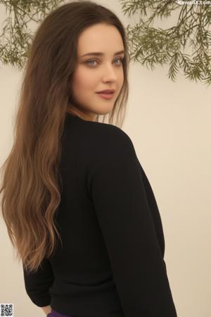 A woman with long brown hair sitting on a red couch.