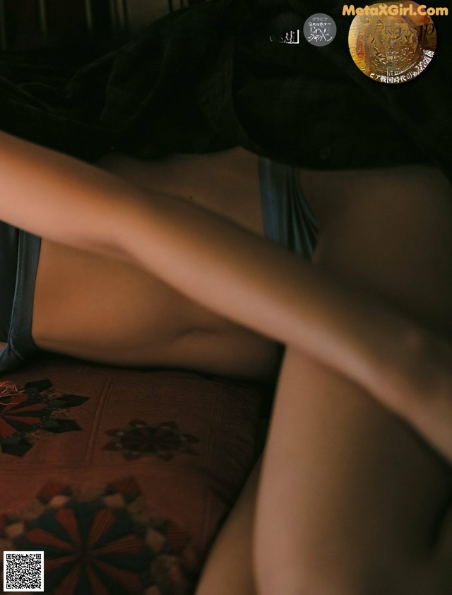 A woman laying on top of a bed in lingerie.