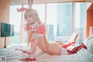 A woman in a bunny costume sitting on the floor.