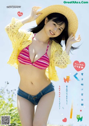 A woman in a pink bikini standing in the water.