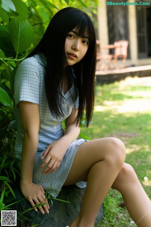 A woman in a black dress posing for a picture.