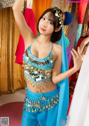 A woman in a red outfit is posing for a picture.