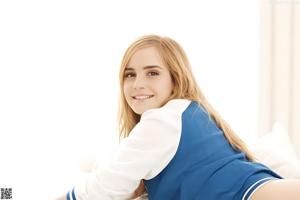 A young woman in a school uniform posing for a picture.