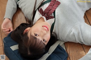 A woman in a school uniform posing for a picture.