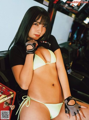 A woman in a bikini playing a video game.