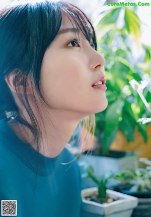 A close up of a woman with long black hair.